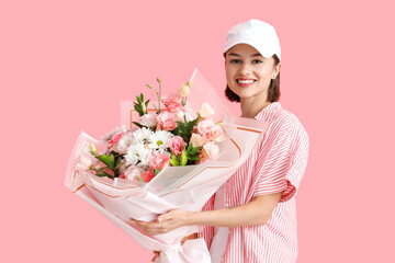 Female courier with bouquet of flowers on color background