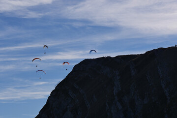 Paraglider flying over mountains in summer day in front of the mountain, High quality photo