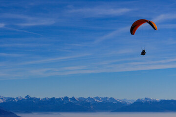Paraglider flying over mountains in summer day in front of the mountain, High quality photo
