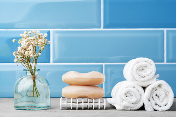 Soap and toiletries on shelf in blue bathroom
