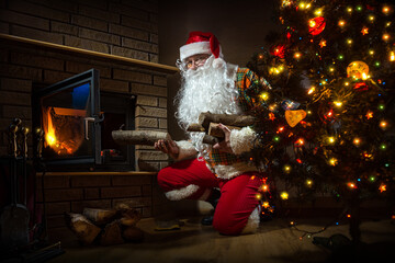 Santa Claus keep the fire in the stove near Christmas tree	
