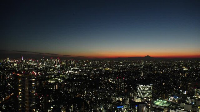 TOKYO, JAPAN : Aerial high angle sunset CITYSCAPE of TOKYO. View of buildings around Shinjuku and Nakano ward. Japanese city life, business and urban metropolis concept. Real time fixed shot.