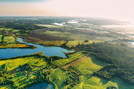 Lyepyel District, Vitebsk Region, Belarus. Aerial View Of Residential Area With Houses In Countryside. Morning Fog Above Lepel Lake. Sun Shining Above Town Skyline And Lepel Lake