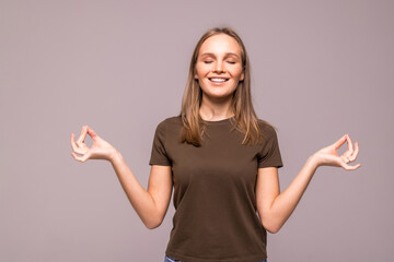 healthy young woman meditating over white background