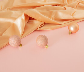Creative vintage Christmas composition with modern golden bauble on pastel pink table against shiny...