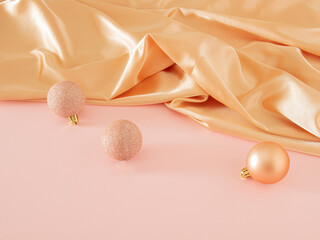 Creative vintage Christmas composition with modern golden bauble on pastel pink table against shiny...