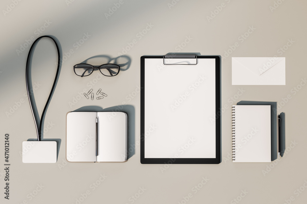Aufkleber top view and close up of empty office supplies on white desktop. clipboard, notepad, bad, envelope. 