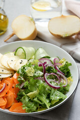 Fresh turnip salad in bowl on grey table, closeup