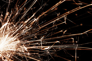 New years eve sparkler isolated on black. Shiny blow of firework sparks. Pyrotechnics background. Fire texture. Happy New Year.