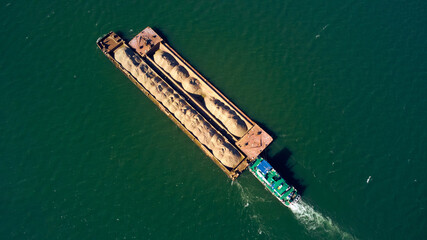 Tankship industrial sand and construction material carrier seen from a drone view. © astrosystem