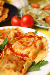 Delicious food concept with ravioli on yellow background