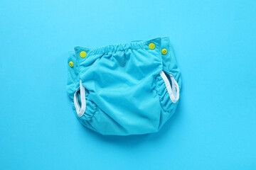 Reusable diapers on blue background, close up