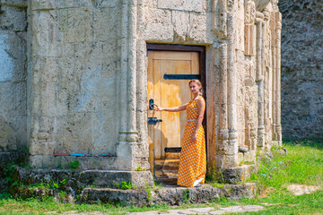 the girl stands on the threshold of the temple