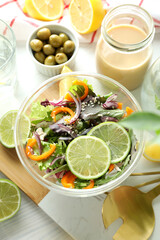 Concept of tasty food with vegetable salad with tahini sauce on white wooden background