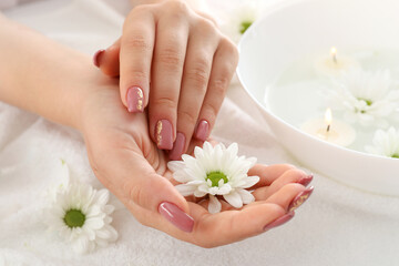 Obraz na płótnie Canvas Concept of hand care with cosmetics on white towel background
