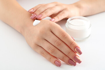 Obraz na płótnie Canvas Concept of hand care with cosmetics on white background