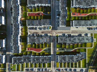 Top view of fresh residential area in Vilnius. City shapes and lines of equally life in the modern town. Block cottages and flats with tiny yards. 