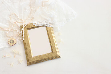 Background of white delicate lace fabric, dry flowers and pearls
