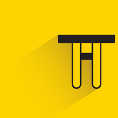 table with shadown on yellow background