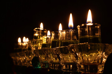 image of jewish holiday Hanukkah background with crystal menorah (traditional candelabra) and oil...