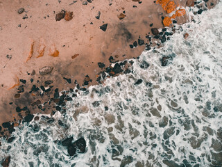 sea ​​waves hitting stones on the beach