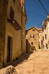 A quiet residential street in the historic medieval centre of Vrbnsk hill village on Krk Island in the Primorje-Gorski Kotar County of western Croatia
