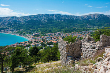 Obraz premium The ruins of the medieval Baska Citadel, Kastel Baska, overlooking the south Krk island town of Baska in the Primorje-Gorski Kotar County of western Croatia 