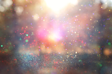 blurred abstract photo of light burst among trees and glitter golden bokeh lights