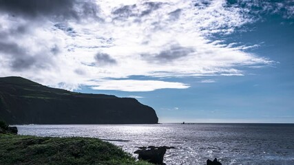 Timelapse of the cliffy coastline of the Azures Island, Portugal clouds arise