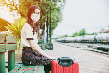 People ware face mask waiting at train station for travel during Covid-19 Pandemic situation