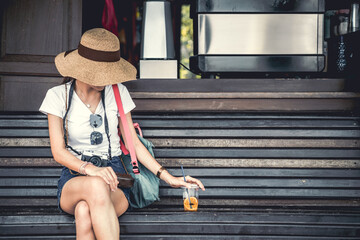 Fototapeta na wymiar summer style fashion tourist traveler sitting relax with tropical fruit juice