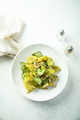 Homemade potato salad with pesto and bacon