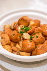 A delicious Chinese dish, shrimp, seafood braised egg tofu in clay pot