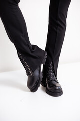 Close up of black womens boots. Fashionable women's stylish leather boots.