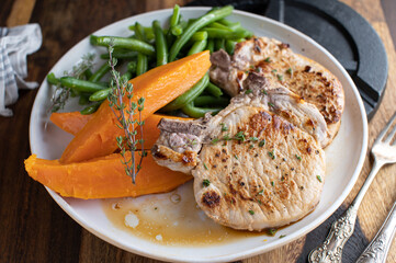 Fitness meal for dinner or lunch with pan fried pork chops, sweet potatoes and green beans