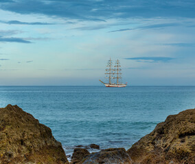 Fototapeta na wymiar Sailing ship off the coast of the Algarve, Portugal.