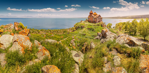 Panoramic scenic view of the famous ancient monastery of Hayravank in Armenia with the legendary Lake Sevan in the background. Travel attractions concept - obrazy, fototapety, plakaty