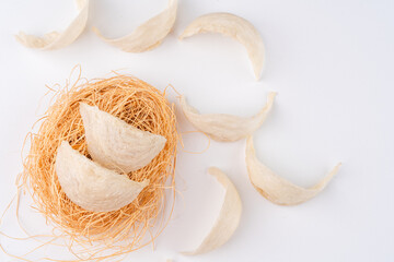 Top Grade edible bird nest shoot on white background with negative space. Raw edible bird's nest...