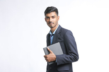 successful Young Indian businessman or employee wearing Suit and cheaking dairy on white background.
