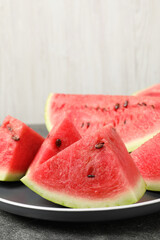Delicious fresh watermelon slices on grey table, closeup