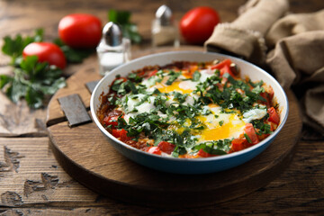 Traditional homemade shakshuka with fresh parsley