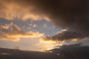 Fototapeta na wymiar Dark dramatic sunset cloudy sky. Nature background. Warm and cool tone.