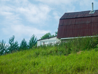 wooden house on a hillock in the village