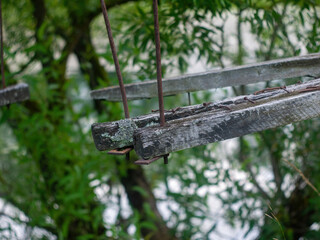 a collapsed wooden pedestrian bridge over the river
