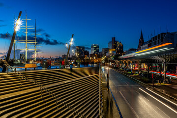Blue hour in the port of Hamburg with stairs and traffic in motion on a nearby cloudless evening