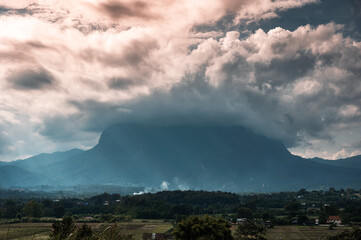 View of Doi Luang Chiang Dao mountain with sunbeam shine and clouds covered in the evening