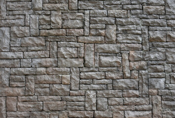 Fototapeta premium Gray stone wall in natural colours pattern texture for background