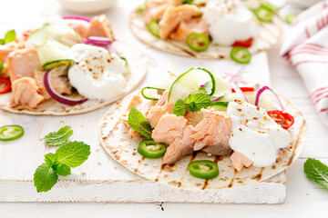 Spicy tacos with grilled salmon, vegetables, ricotta cheese, chili and fresh mint
