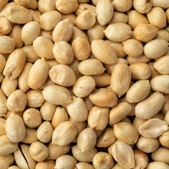 Closeup top view of peeled peanuts. Food backdrop