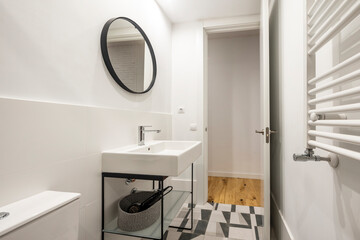 Modern design shower toilet in white, black and gray colors with round mirror and white wall mounted radiator